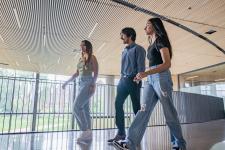 three students walking in DU's community commons